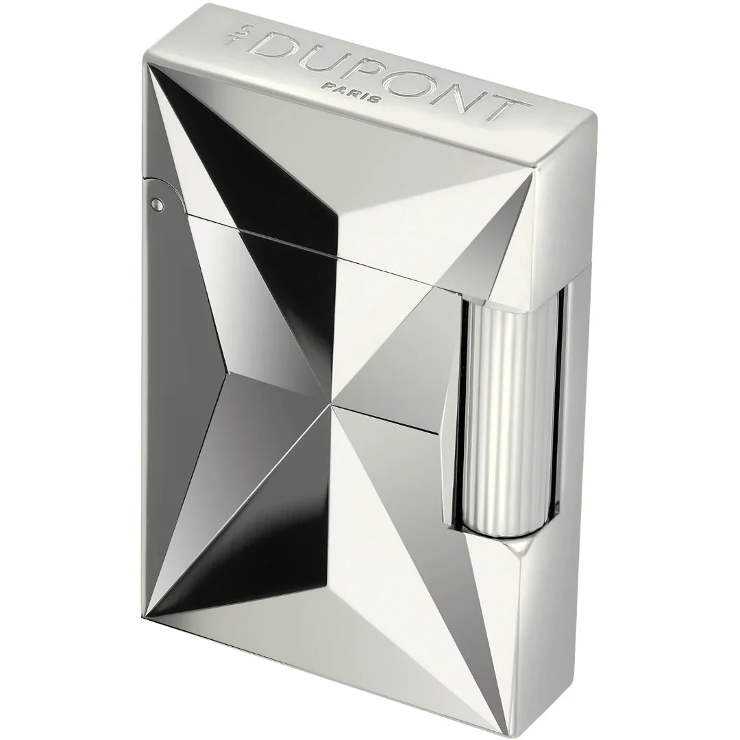 A silver metallic lighter with a faceted geometric design and a ribbed wick visible on the side, branded 'The Dupont Paris' on the top surface, set against a plain white background.