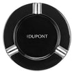 Black porcelain cigar ashtray with gunmetal rests and S.T. Dupont branding, circular design with central well.
