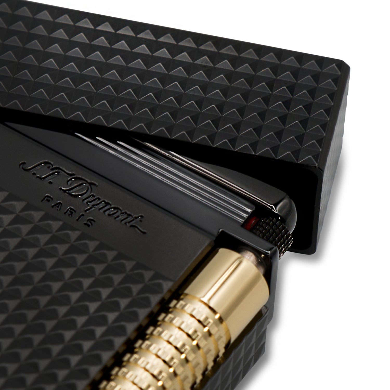 Close up of a black lighter with gold accents on a white background