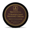 Black bowl with brown and gold label reading "Taylor of Old Bond Street Tobacco Leaf Shaving Cream," 150g.