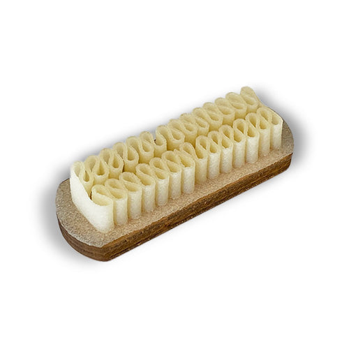 A white Wellington Crepe Brush for Suede and Nubuck bar on a white surface using natural rubber crepe brush by KirbyAllison.com.