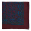 Burgundy pocket square with blue paisley pattern on a white background