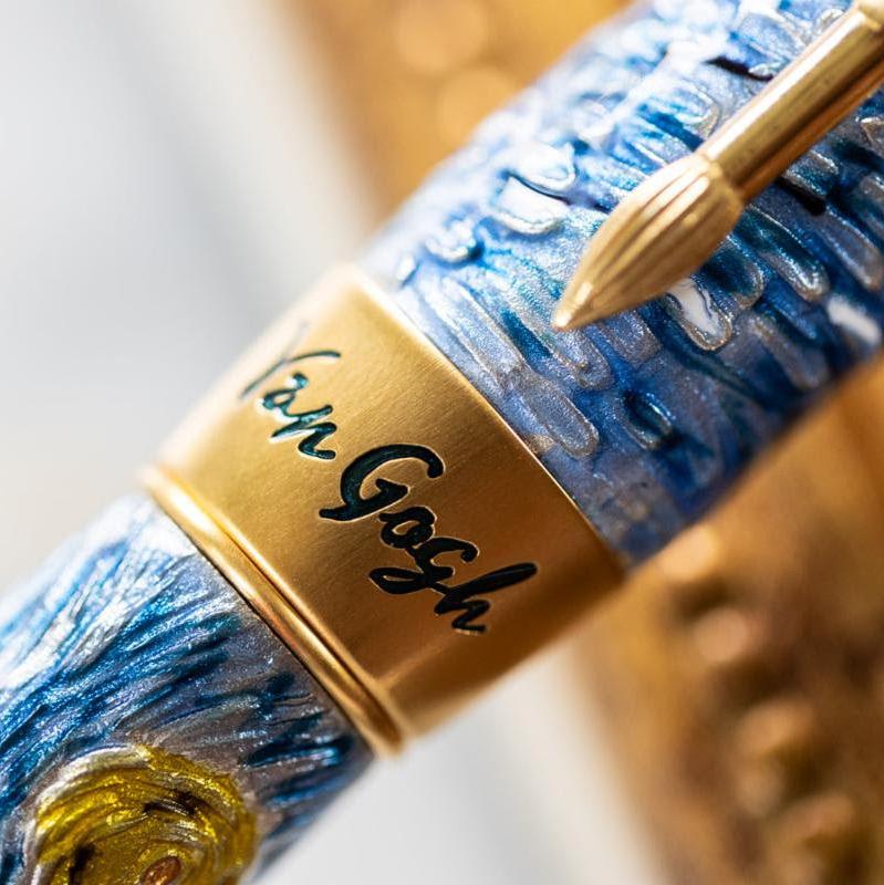 Close-up image of the Visconti Van Gogh Dreaming Starry Night Fountain Pen with "Van Gogh" engraved on a gold band and a textured blue design from the Limited Edition collection.