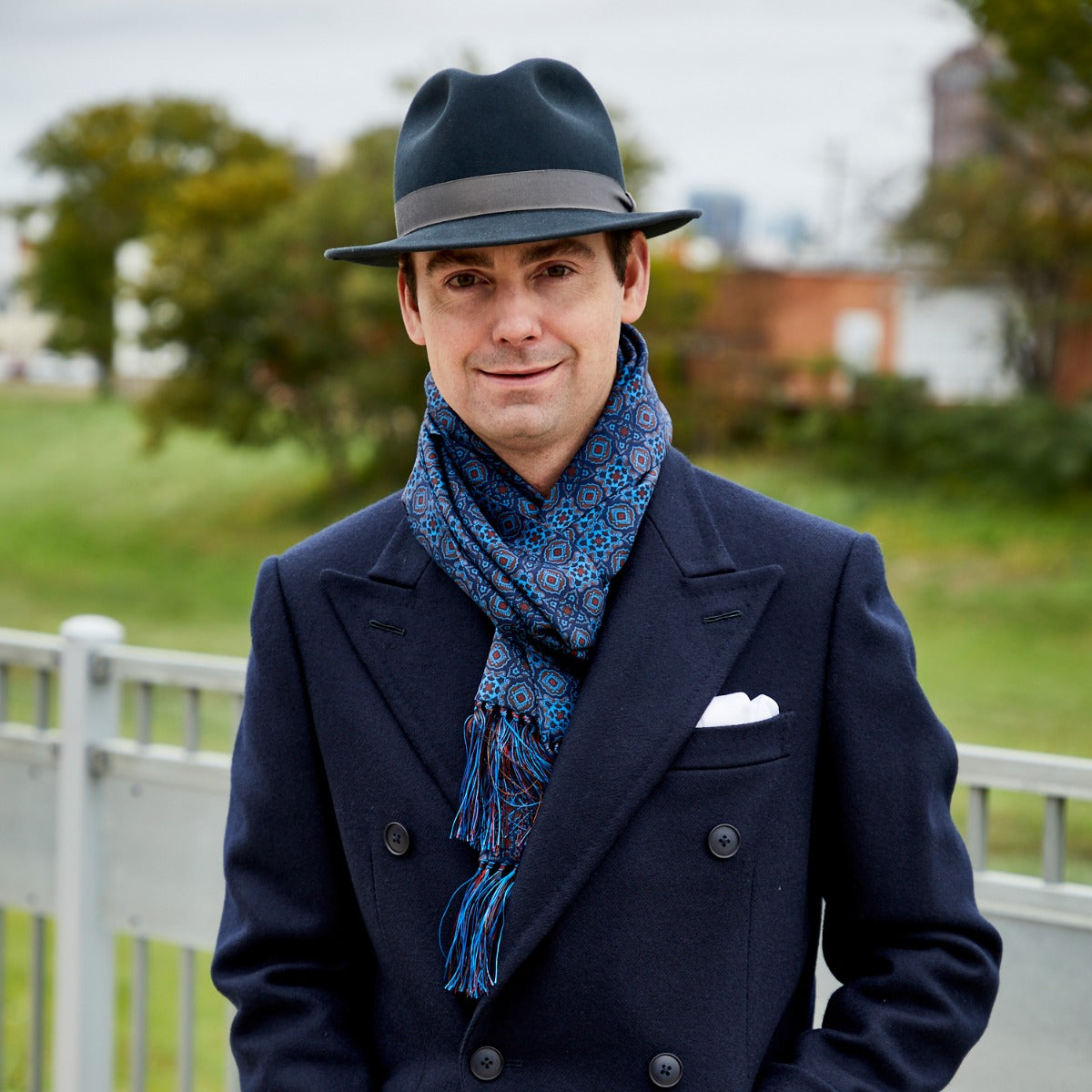 A man wearing a Sovereign Grade Ancient Madder Blue Motif Silk Scarf made by KirbyAllison.com.