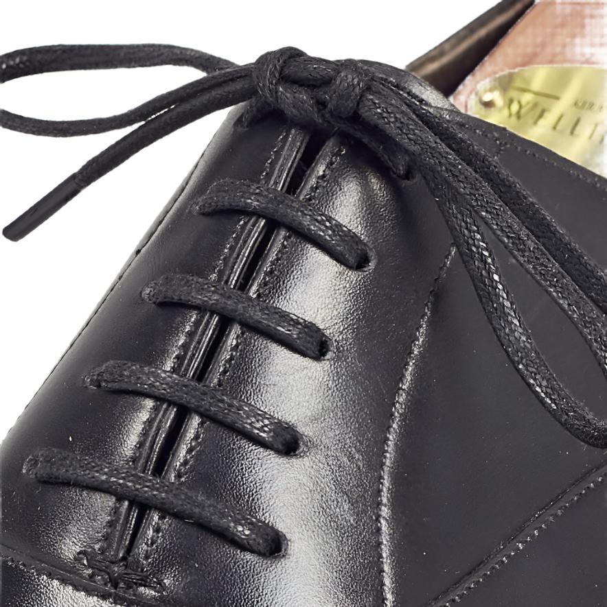 A close up of a black oxford dress shoe with KirbyAllison.com Wellington Flat Waxed Dress Shoelaces.