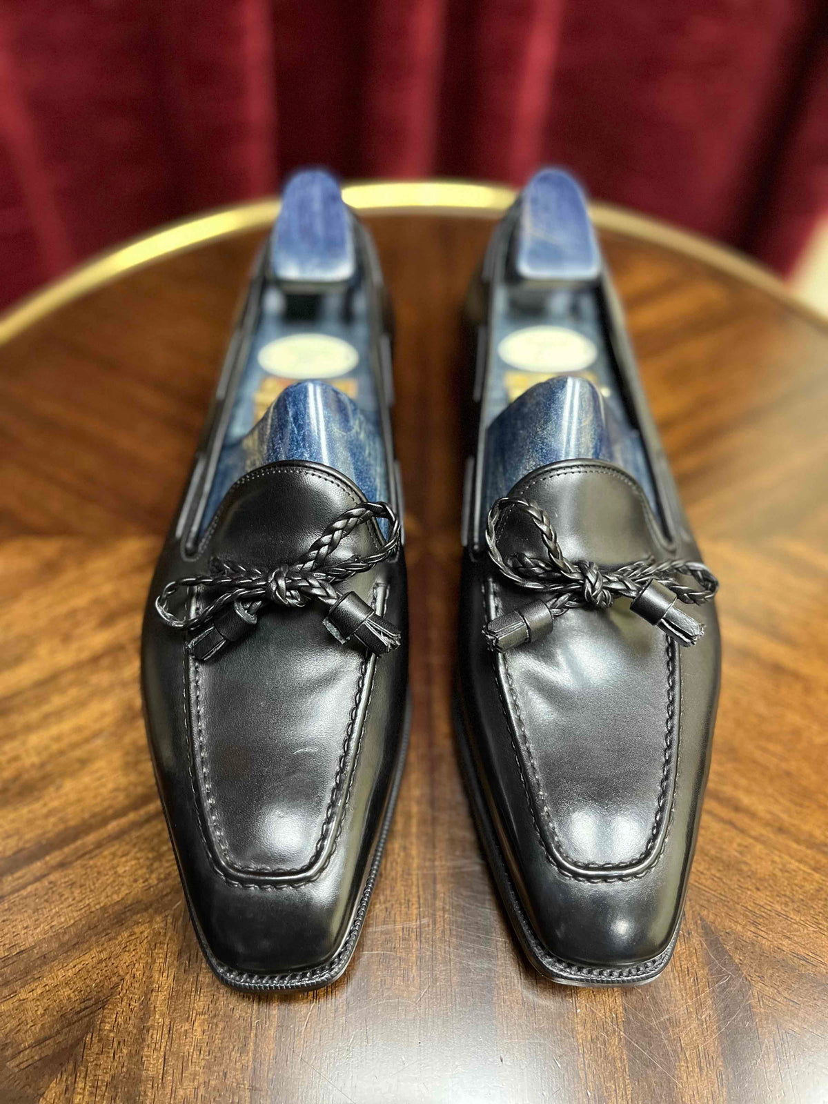 A pair of Anthony Cleverley Baron de Rede Black Casual Loafers, UK 9.0 Wide, from KirbyAllison.com on a table.