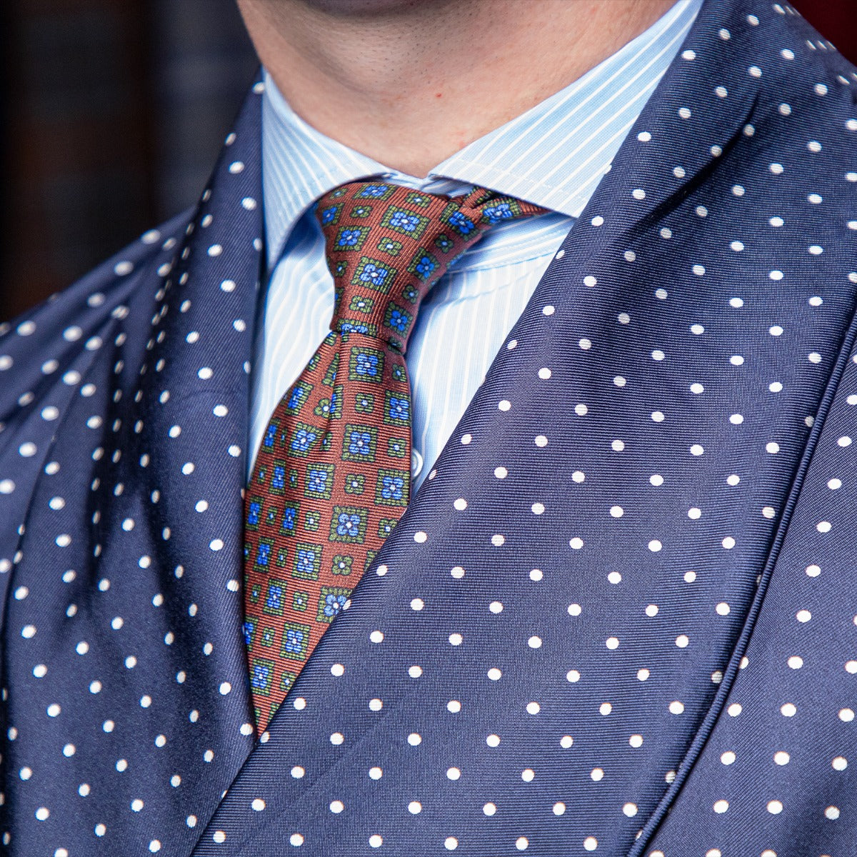 A man in a blue suit with a KirbyAllison.com Sovereign Grade Navy London Dot Dressing Gown.