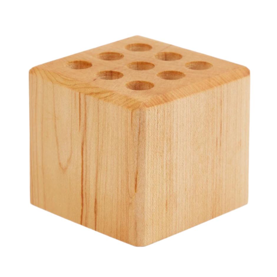 A premium wooden cube with holes in it, perfect as a Hanger Project Large Collar Stay Holder from KirbyAllison.com.