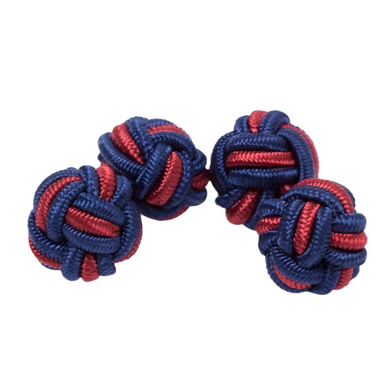 A pair of Dual Colored Knot Cufflinks, one blue and one red, on a white background from KirbyAllison.com.