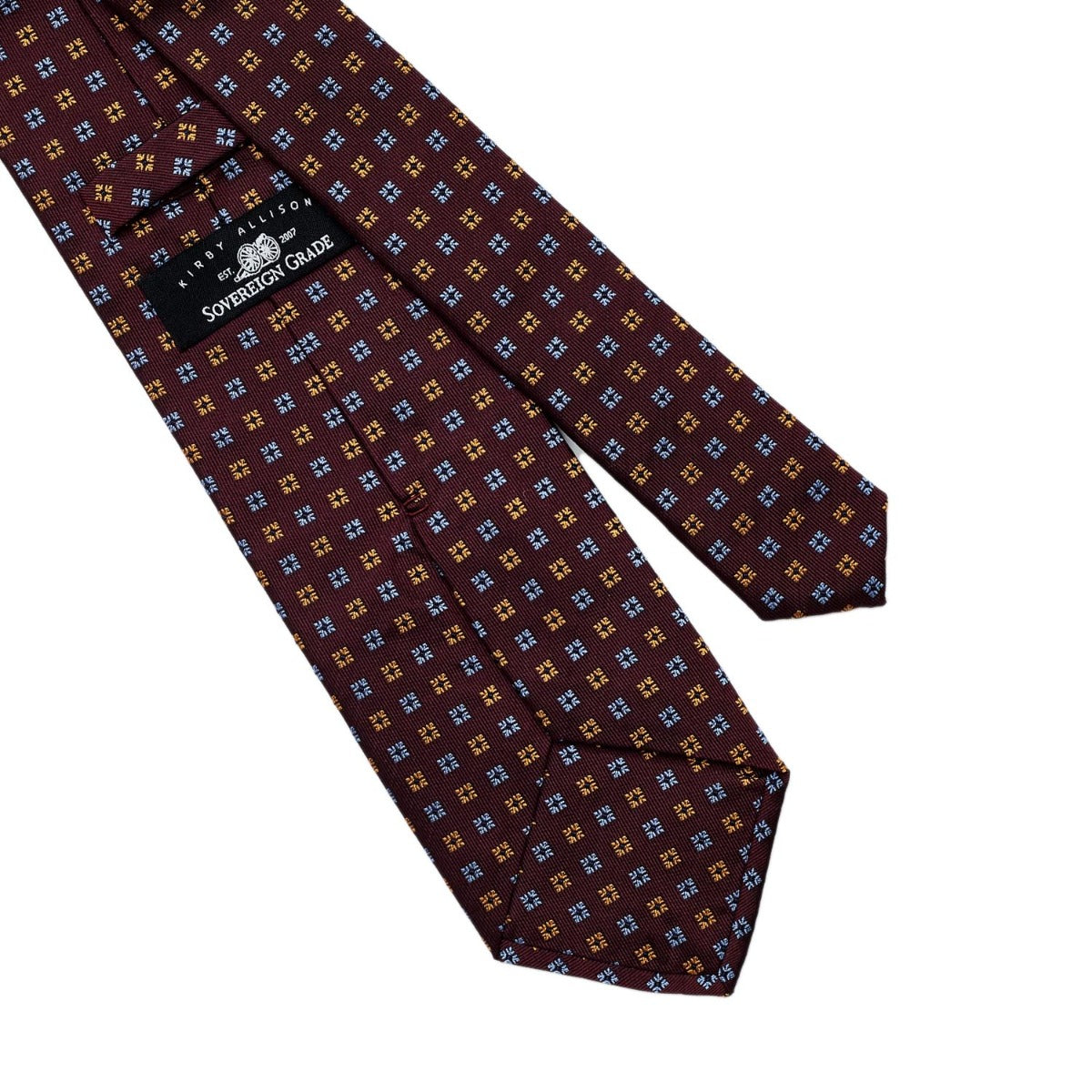 A high-quality Sovereign Grade Burgundy Diamond Motif Jacquard Tie featuring a blue and brown pattern, available at KirbyAllison.com.