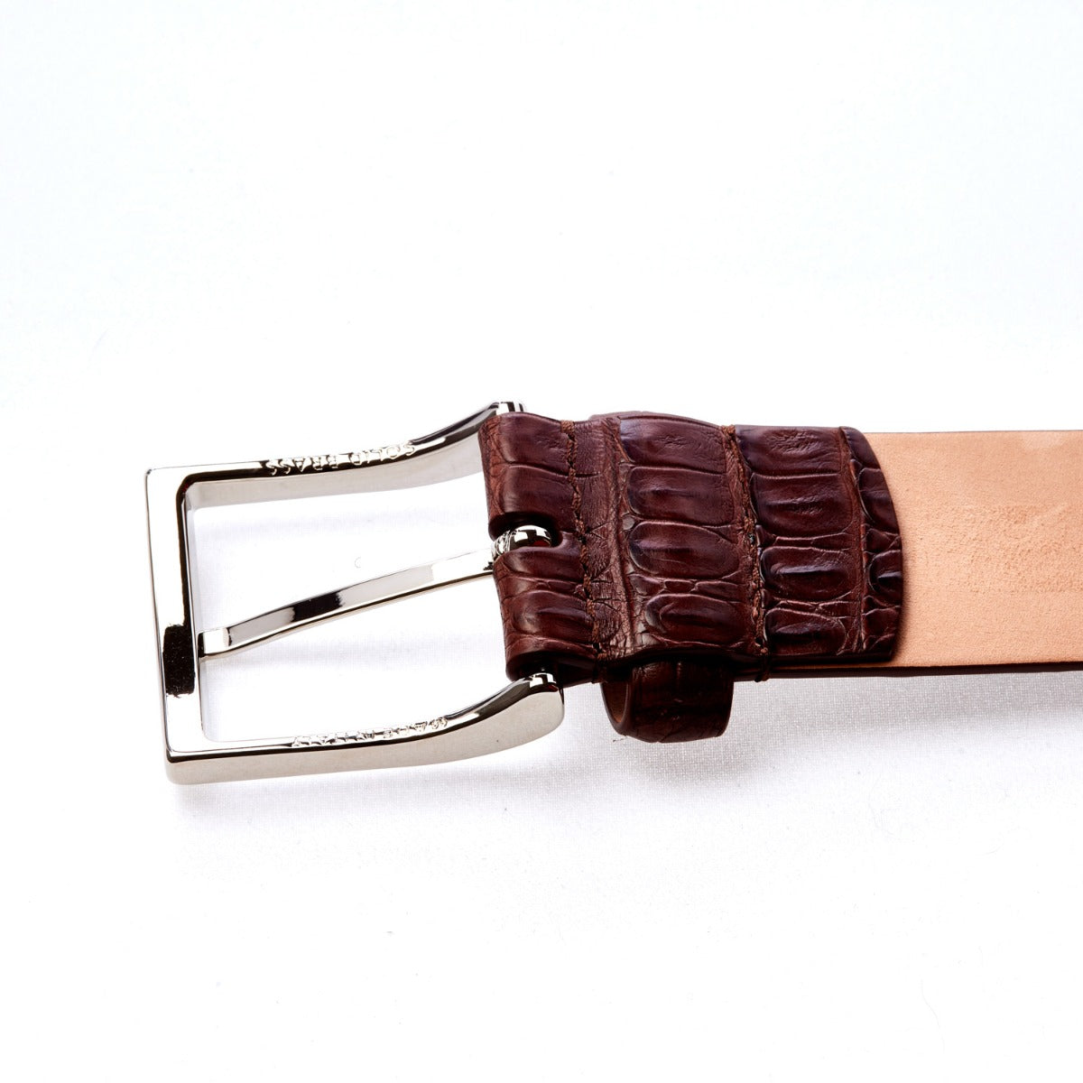 A Sovereign Grade Cognac Crocodile Belt from KirbyAllison.com with a satin finish.