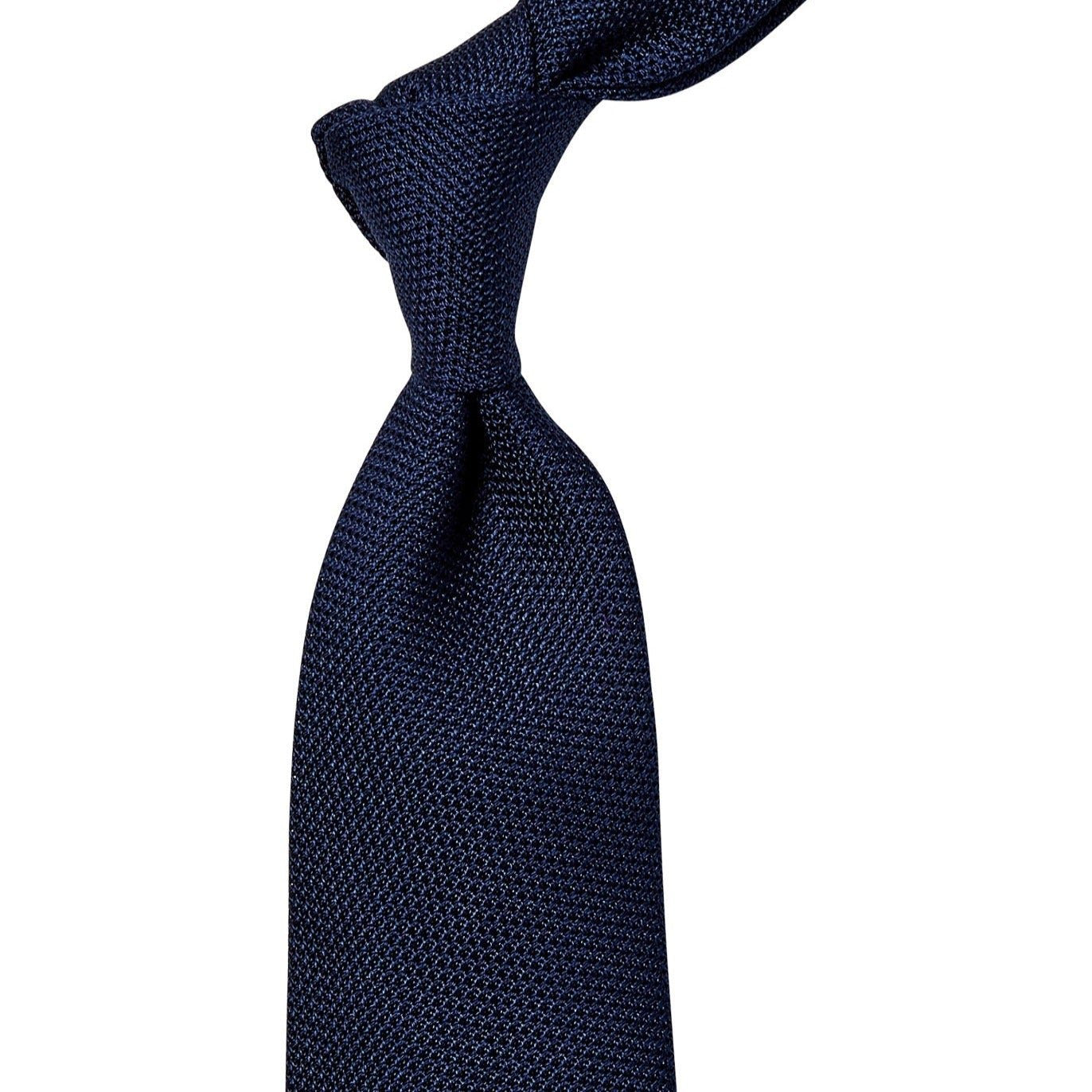 A handmade Sovereign Grade Grenadine Fina Navy Tie from KirbyAllison.com, made in the United Kingdom, on a white background.