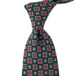 A green Sovereign Grade Forest 36oz Printed Silk Maccesfield tie with red and blue designs, handmade in the United Kingdom using 100% English silk by KirbyAllison.com.