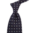 A KirbyAllison.com Sovereign Grade Midnight Blue Square Floral Jacquard Tie featuring a blue flower pattern on a white background.