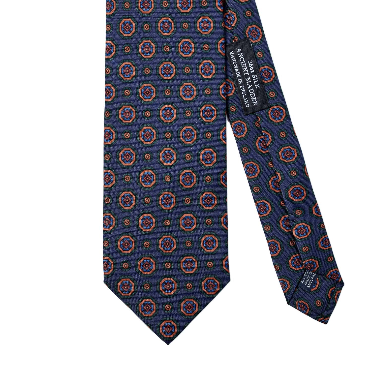 A Sovereign Grade Dark Navy Geometric Ancient Madder Tie (150x8.5 cm) with a circular pattern, handmade in the United Kingdom, from KirbyAllison.com.