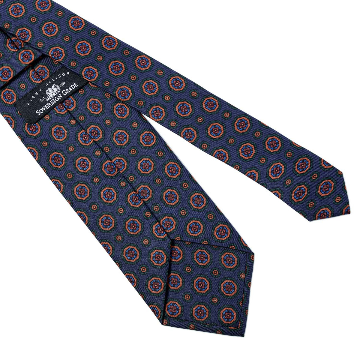 A handmade necktie with a circular pattern on it, representing the highest quality of Kirby Allison Sovereign Grade Dark Navy Geometric Ancient Madder ties (150x8.5 cm) available at KirbyAllison.com.