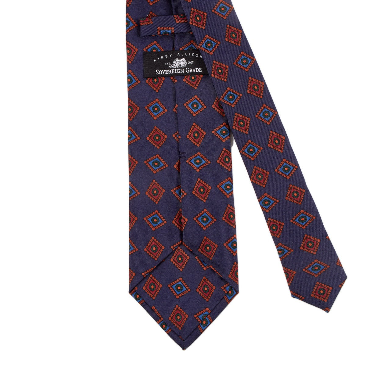 A Sovereign Grade Dark Navy Art Deco Ancient Madder Silk Tie with an orange and blue pattern from KirbyAllison.com.