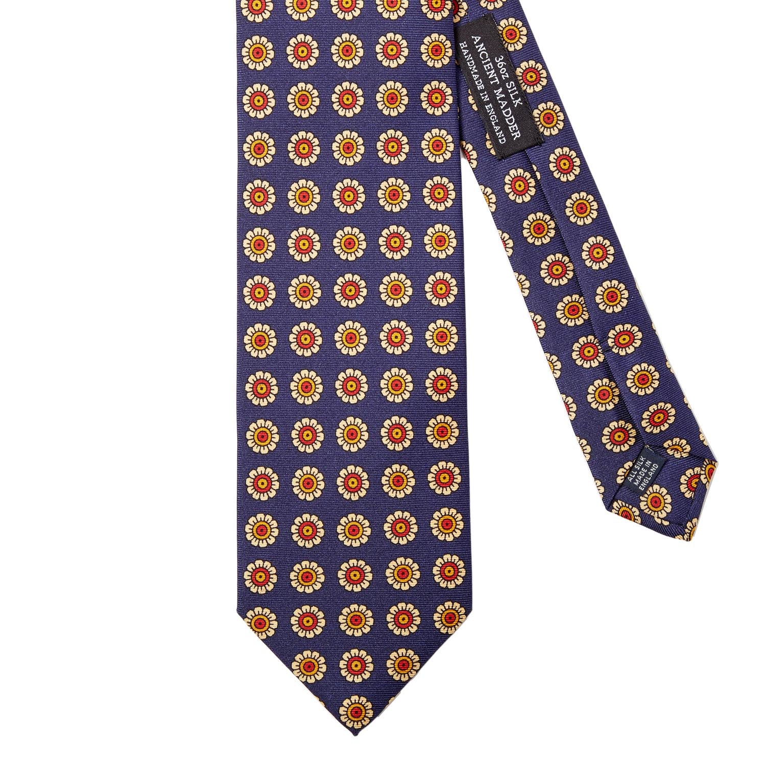 A Sovereign Grade Navy Daisy Spring Madder Buff Tie (150x8.5 cm) made by KirbyAllison.com, handmade with 100% English silk and adorned with orange and yellow flowers.