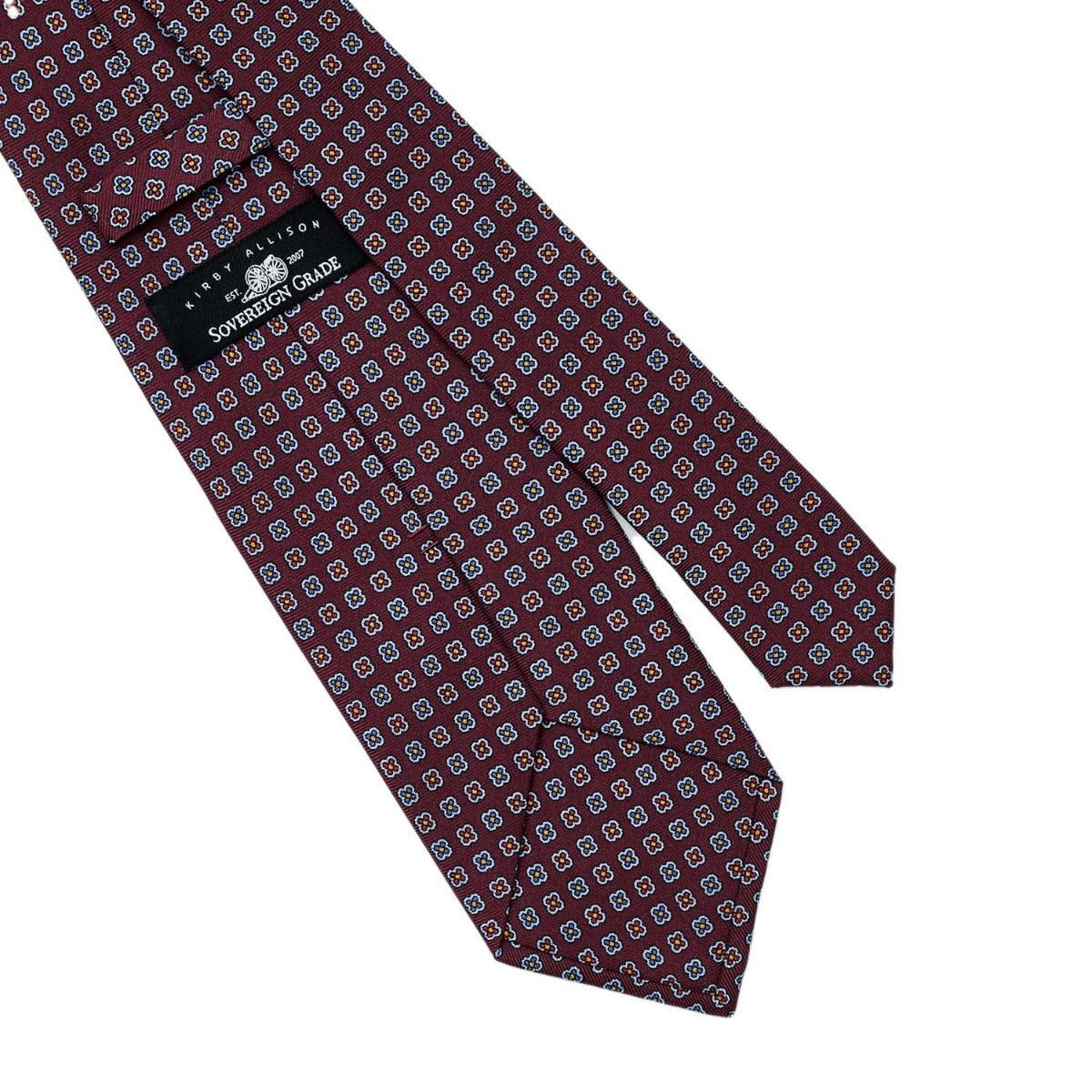 A high-quality handmade Sovereign Grade Burgundy Daisy 36oz Printed Silk Tie with a United Kingdom-inspired blue and red pattern from KirbyAllison.com.