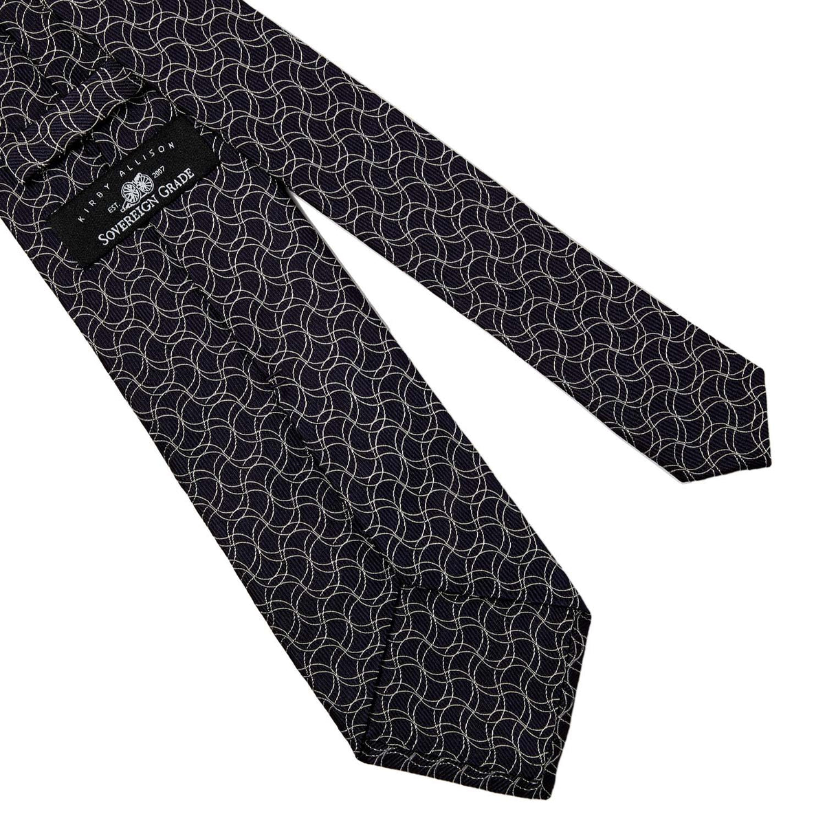 A Sovereign Grade Navy and White Swirl Jacquard Tie from KirbyAllison.com with a geometric pattern on it.