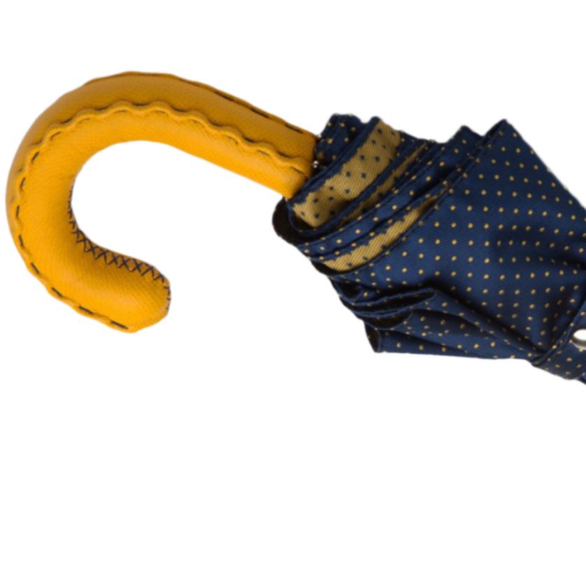 A Navy Yellow-Dot Travel umbrella with a yellow leather handle from KirbyAllison.com.