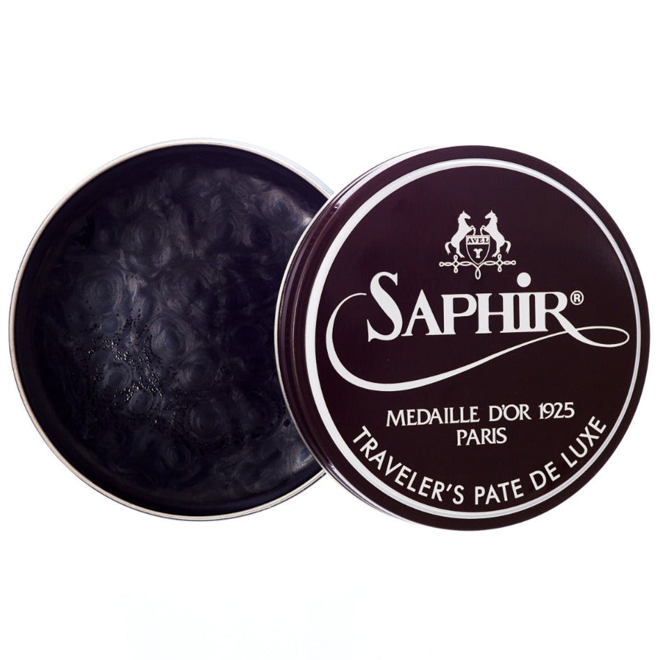 A tin of Saphir Traveler's Pate de Luxe Wax Shoe Polish by KirbyAllison.com on a white background.