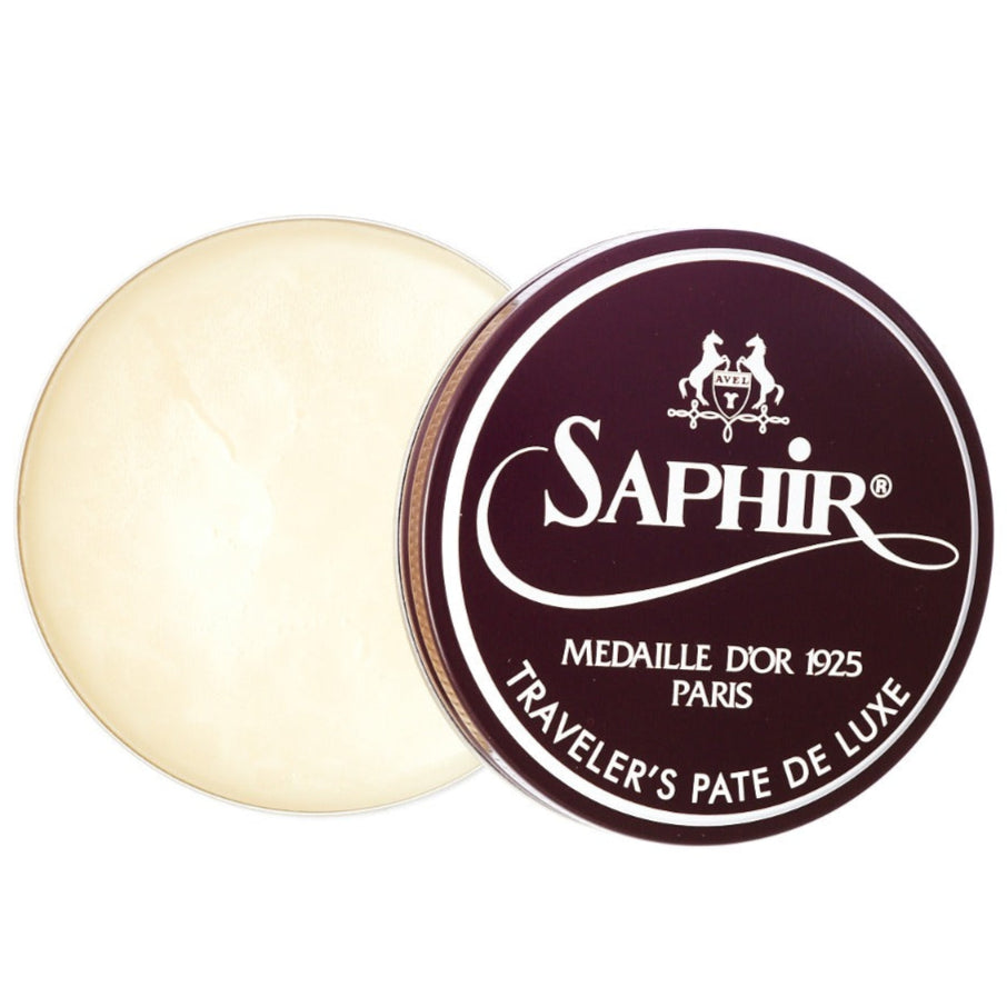 A tin of Saphir Traveler's Pate de Luxe Wax Shoe Polish by KirbyAllison.com on a white background.