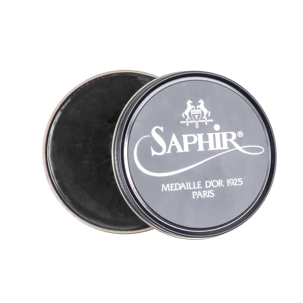 A black tin with the words "Saphir Pate de Luxe Wax Shoe Polish 50 ml" and "KirbyAllison.com" high-gloss shoe shine on it.