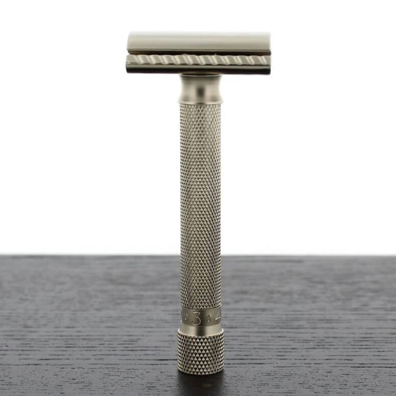 A KirbyAllison.com Parker Variant Adjustable Safety Razor on top of a table.