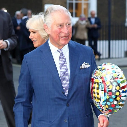 The duke and duchess of cambridge are holding Sovereign Grade Prince of Wales Pocket Square, Navy/Burgundy balloons from KirbyAllison.com.