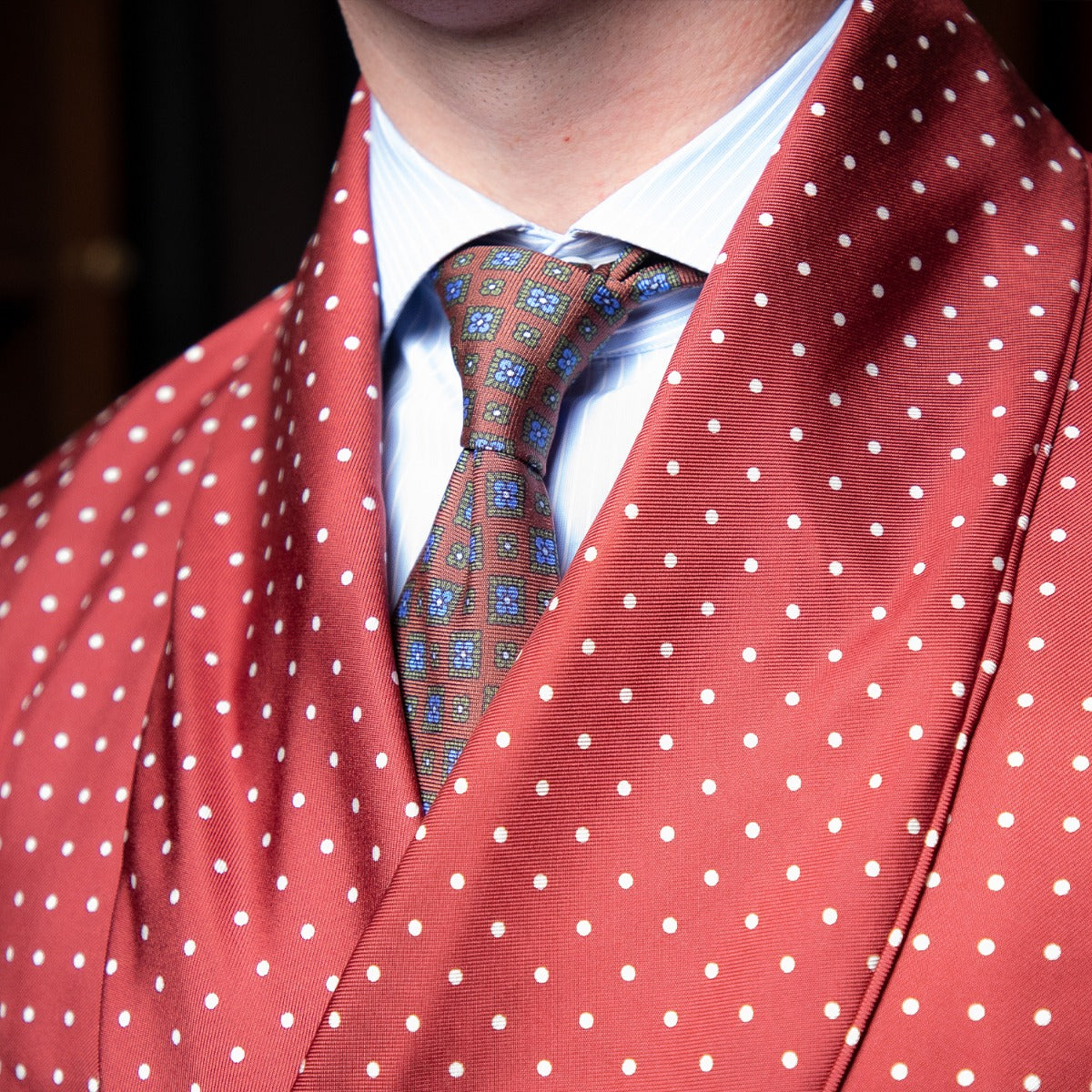 A man wearing a KirbyAllison.com Sovereign Grade Burgundy London Dot Dressing Gown.