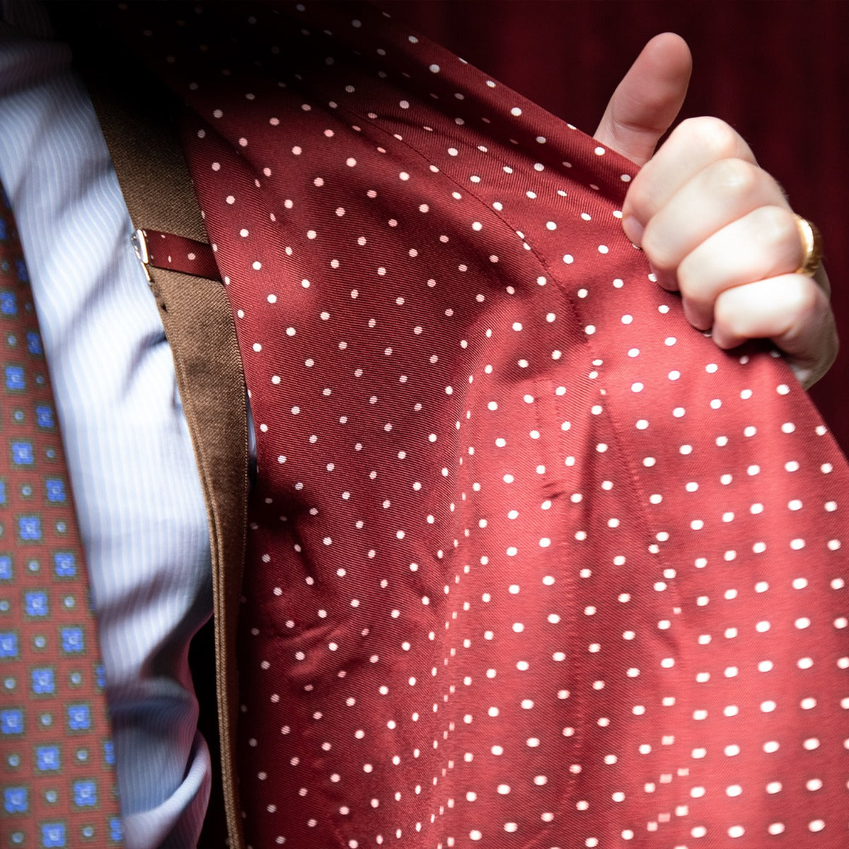 A man wearing a Sovereign Grade Burgundy London Dot Dressing Gown by KirbyAllison.com.