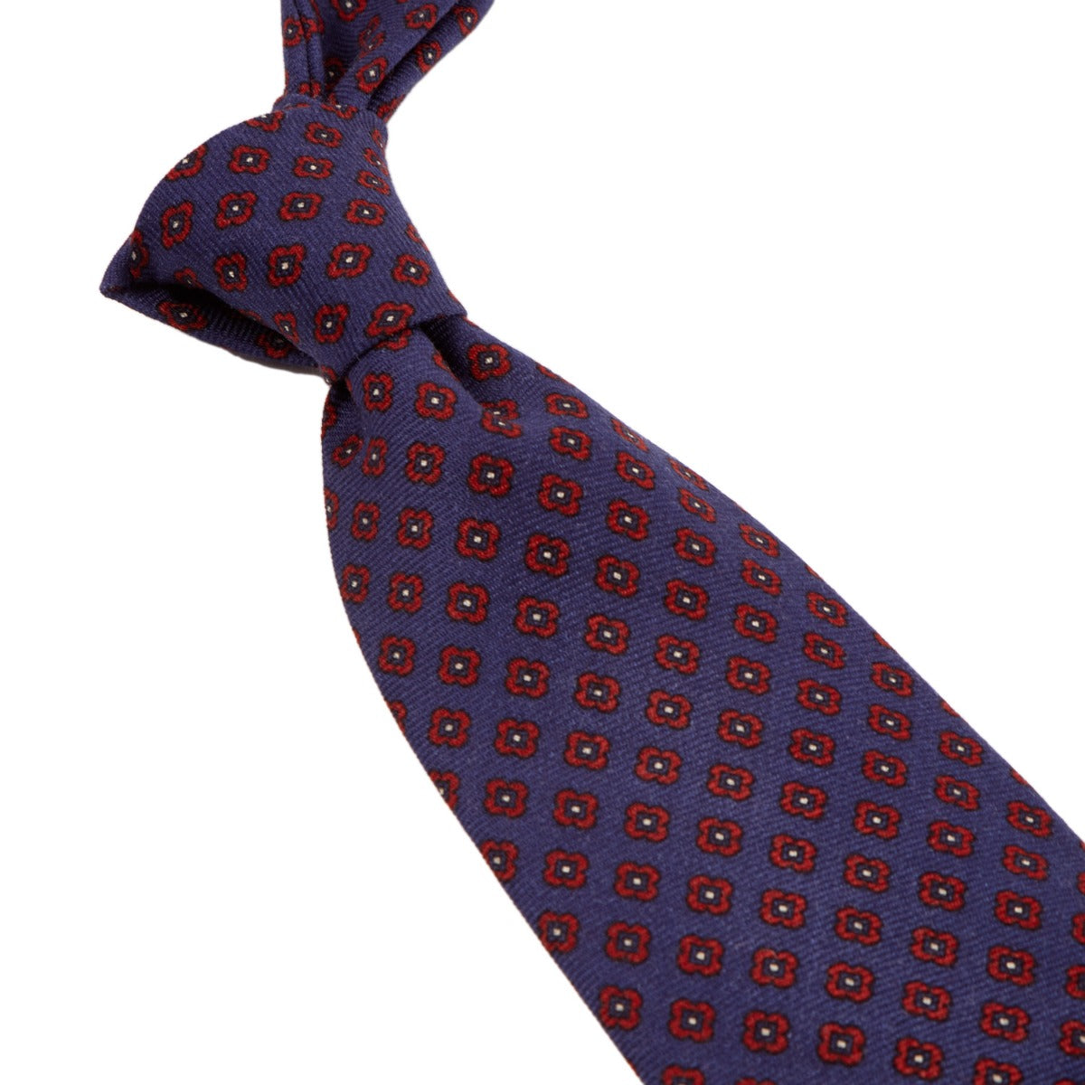 A Sovereign Grade Butcher Blue Small Floral Wool Challis Tie from KirbyAllison.com with a red and blue pattern from the United Kingdom.