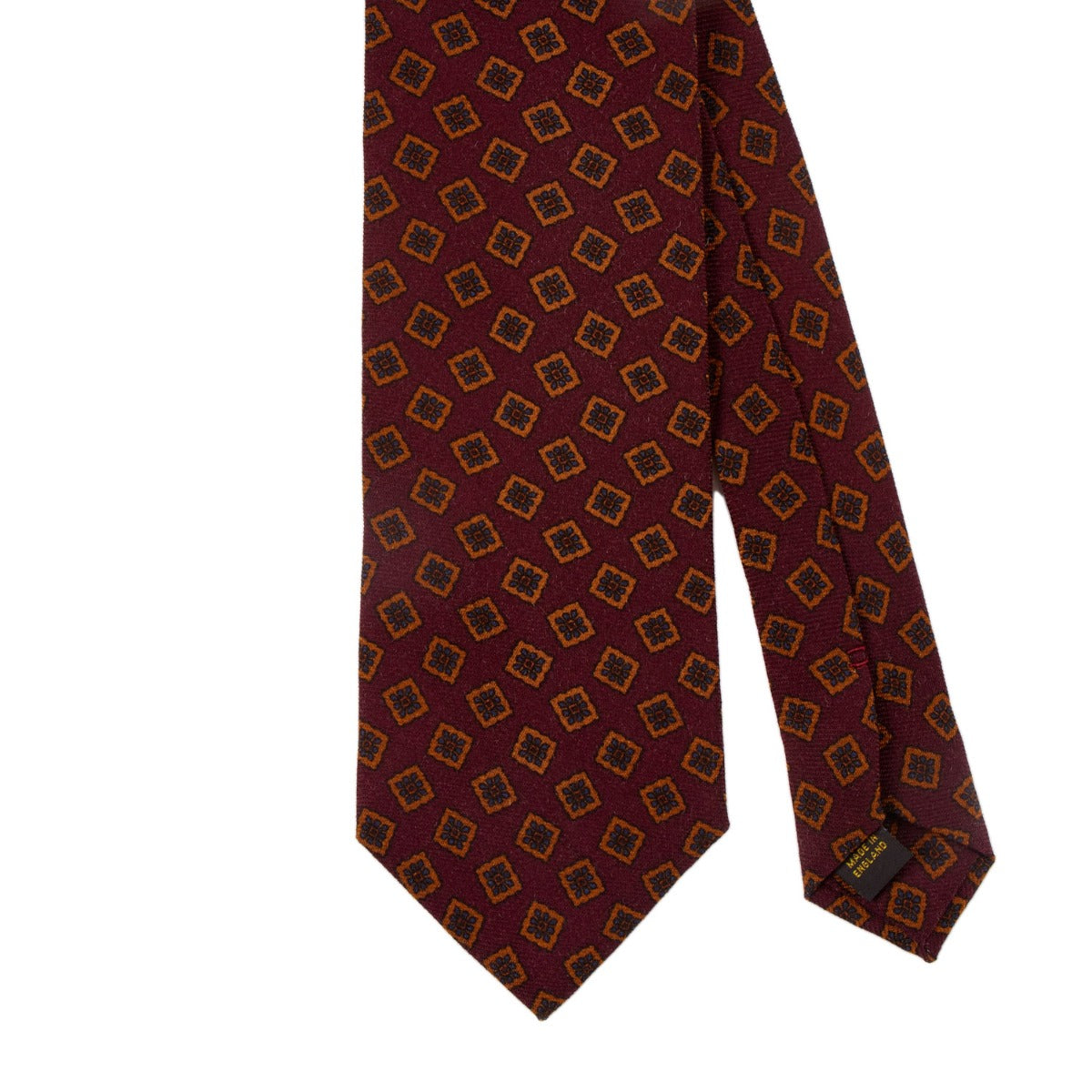 A handmade Sovereign Grade Burgundy Tossed Square Wool Challis Tie with a geometric pattern, crafted to the highest quality standards by KirbyAllison.com in the United Kingdom.