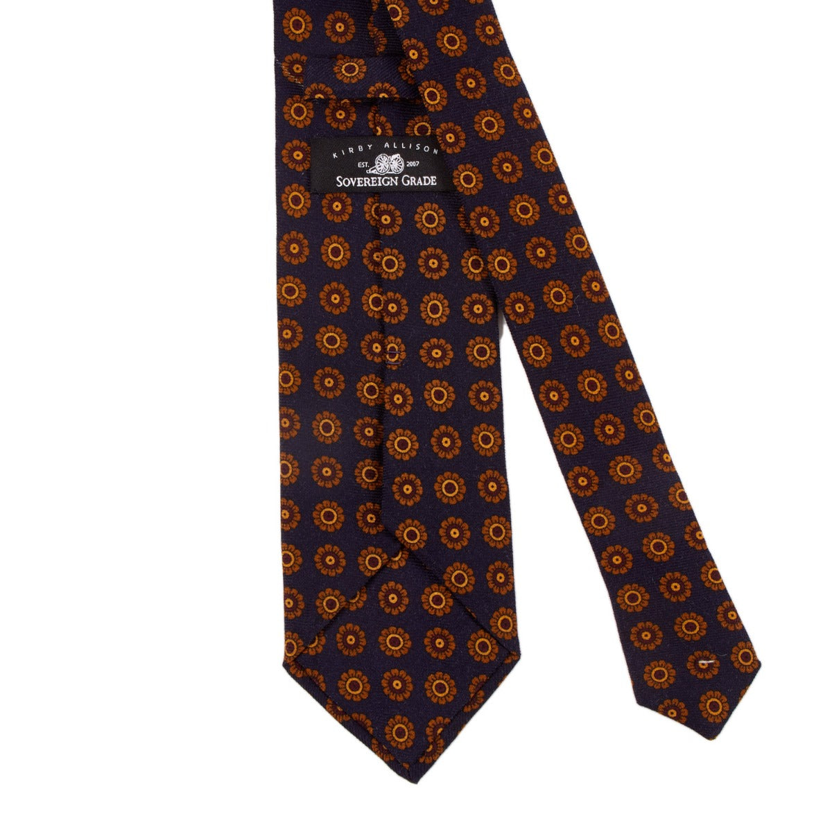 A handmade Sovereign Grade Navy Daisy Wool Challis Tie with orange and blue circles, perfect for the United Kingdom, by KirbyAllison.com.